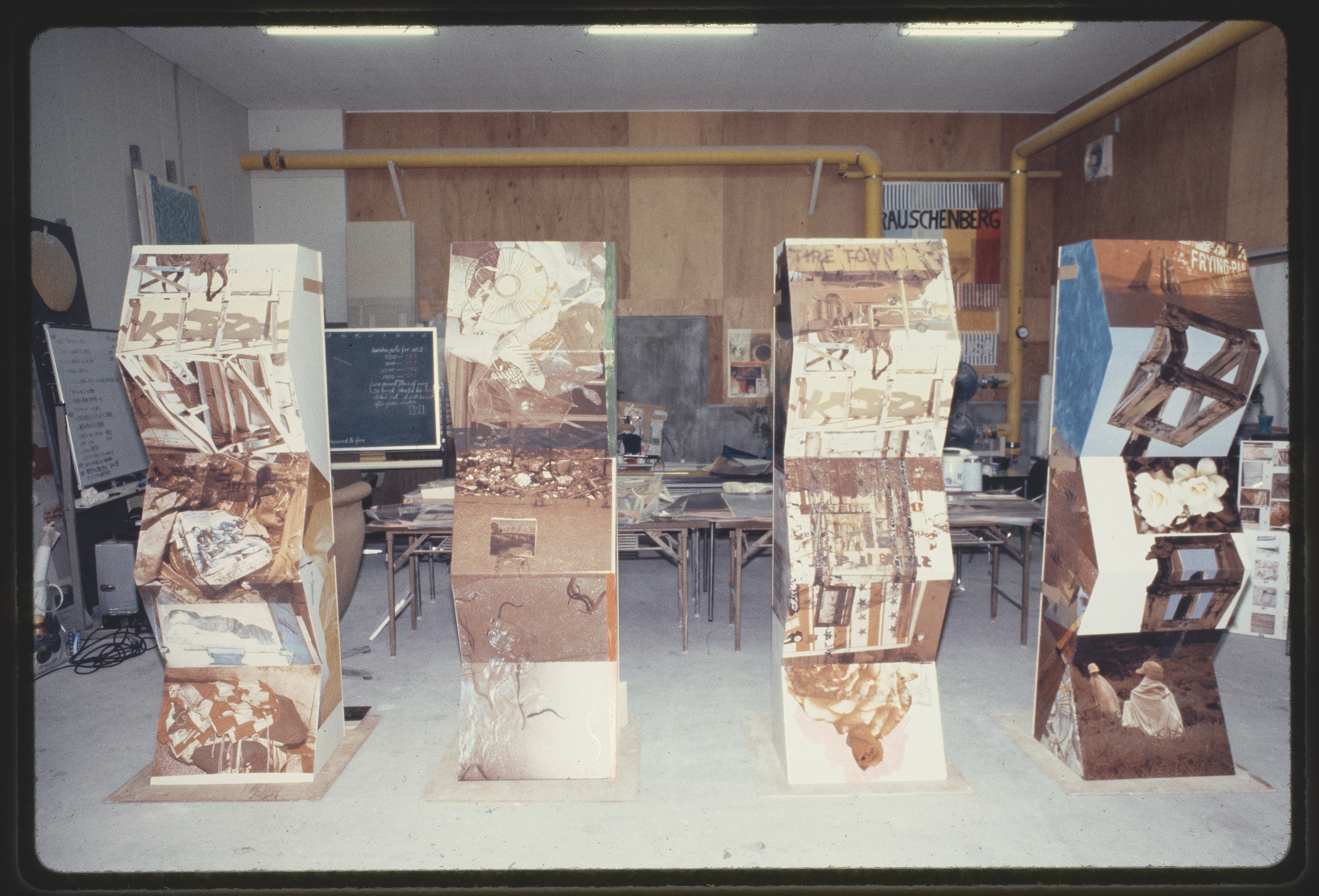 Four large, rectangular sculptures lined up in a row